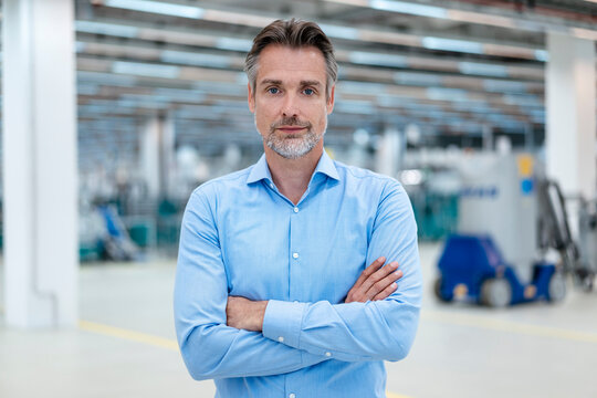 Portrait of confident businessman in a factory hall