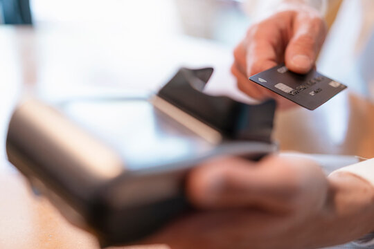 Man using credit card reader, close-up