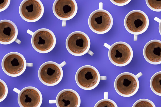 Directly above view of fresh coffee in cups over purple background