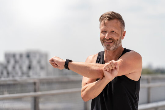 Sporty man stretching outside