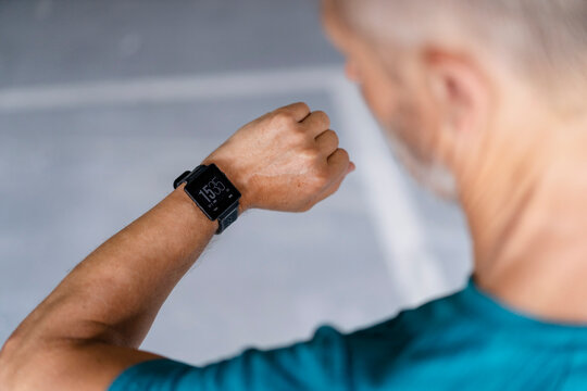 Sporty man checking his smartwatch