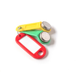 two touch memory keys yellow and green with a red tag lie on a white background. the concept of security and access restrictions.