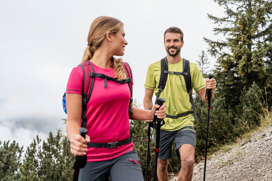 Confident young couple on a hiking trip in the mountains, Herzogstand, Bavaria, Germany