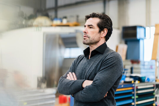 Portrait of a pensive businessman in a factory