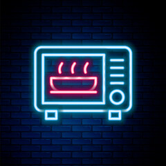 Glowing neon line Microwave oven icon isolated on brick wall background. Home appliances icon. Colorful outline concept. Vector