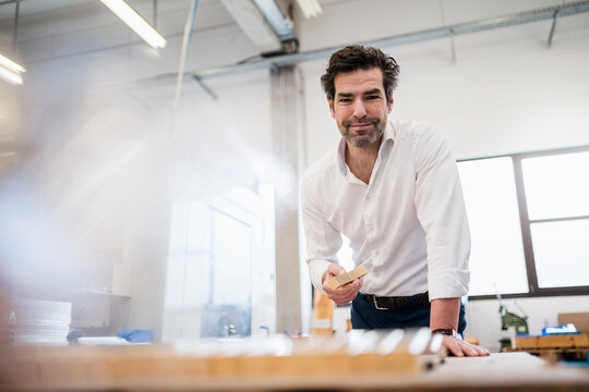 Portrait of a confident businessman in a factory