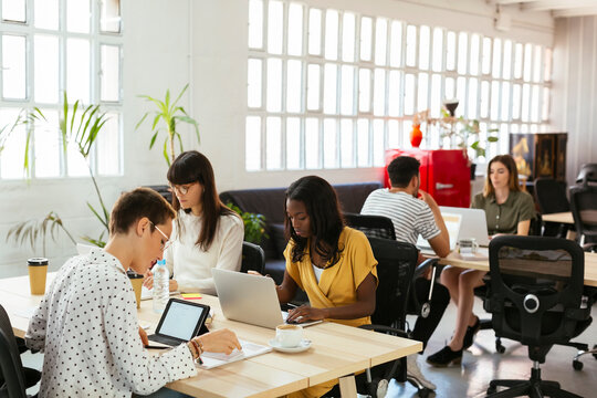 Colleagues working at desk in office