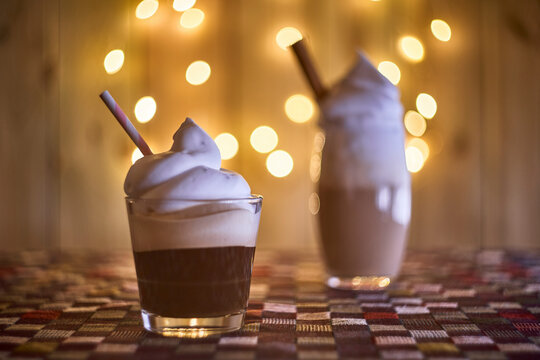 Coffee with cream with bokeh lights on the background