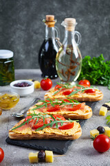 Grilled bruschetta with chicken rillettes, jamon and herbs. Delicious toast with chicken pate and different appetizers