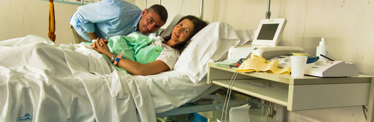 Husband and wife at the hospital after giving birth to their newborn child