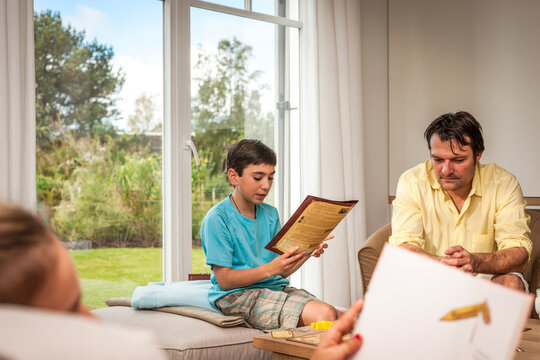 Father playing with son in living room