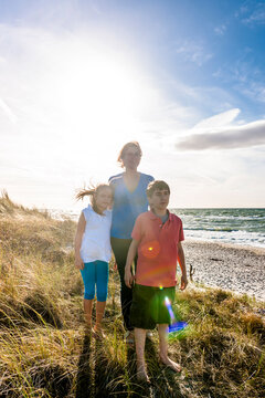 Mother with two children in a beach dune at the sea, Darss, Mecklenburg-Western Pomerania, Germany