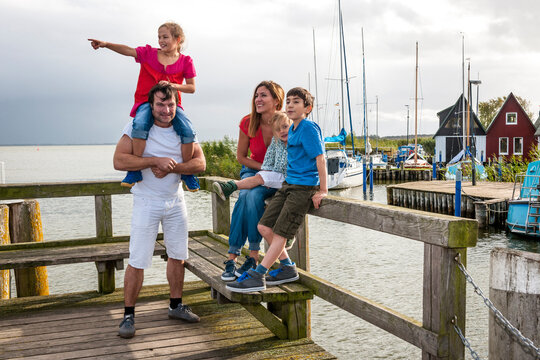 Happy family on a pier, Ahrenshoop, Mecklenburg-Western Pomerania, Germany