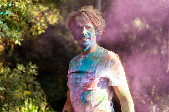 Man covered in powder paint, celebtaing Holi, Festival of Colors
