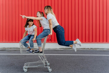 Mother with her children with shopping cart