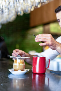 Close-up of barkeeper preparing a coffee cocktail