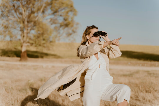 Female traveller looking through binoculars