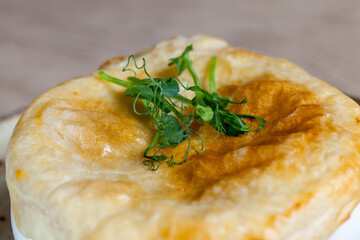 dough on a bowl of soup baked together in the oven