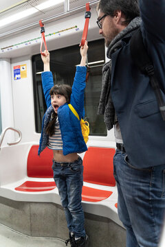 Father and daughter in metro