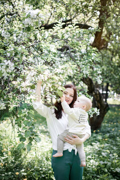 Mother with her baby boy at a tree in park