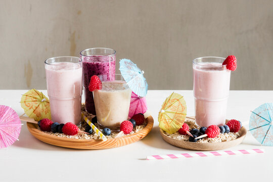 Glasses of berry smoothies with oat flakes