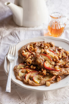 Plate of gluten free buckwheat pancakes with banana, apple and nuts