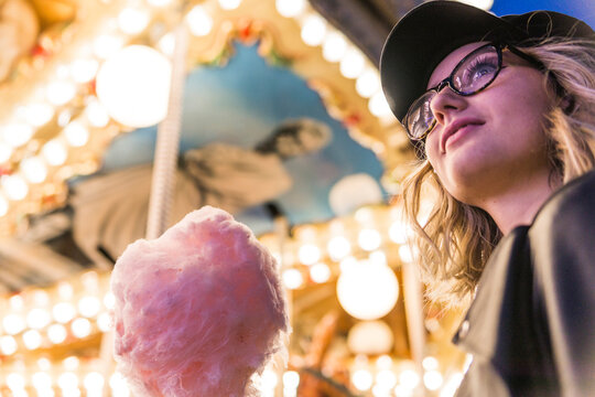 Teenage girl with pink candyfloss at fair