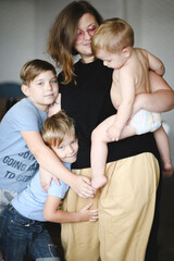 Portrait of mother with her three sons at home