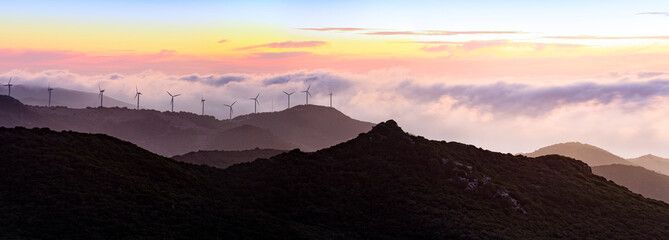 Gibraltar, Wind turbines in landscape at sunset