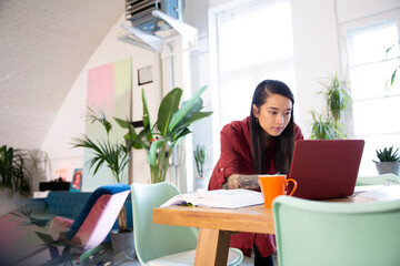 Woman using laptop in office