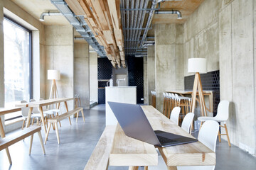 Laptop on wooden boards in modern office