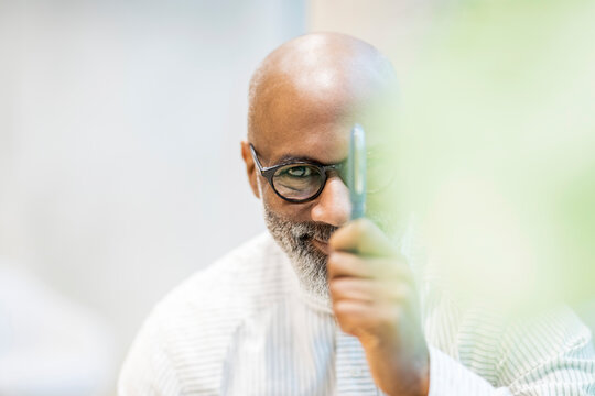 Portrait of bald businessman with pen