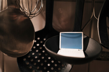 Food, cooking spoon and tablet