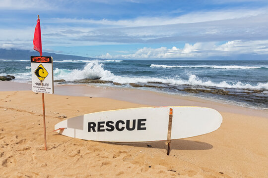 Rescue surfboard, red flag and warning sign at Ho'okipa Beach Park, Hawaii, USA