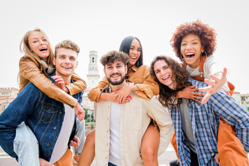 Young Friends having Fun Outdoors - Six students outdoors, men carrying two girls on their backs