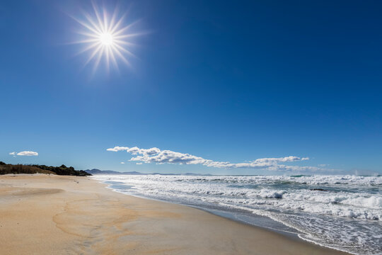 New Zealand,ÔøΩKakaÔøΩPoint, SunÔøΩshining over sandy coastal beach