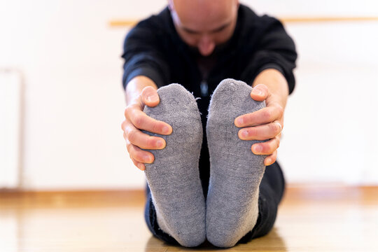 Ballet dancer stretching in ballet studio