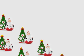 Pattern with Christmas ornaments including Santa Claus and Christmas tree on white background.