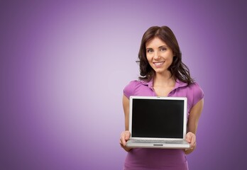 Naklejka premium Smiling cheerful funny beautiful attractive young woman working on laptop pc