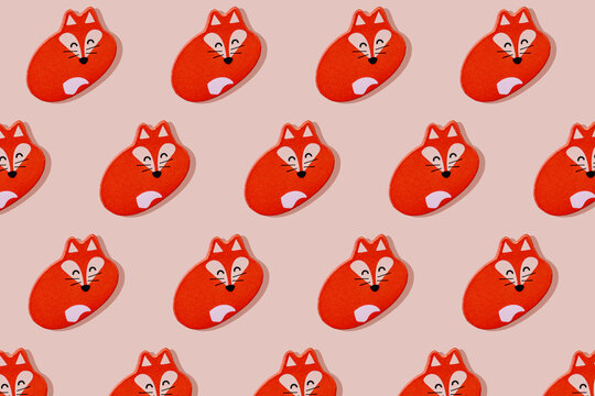 Sleeping happy fox in a row on pink background