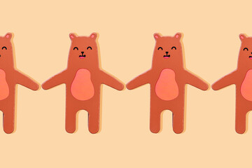 Brown bears wooden toy in a row holding hands on a yellow background
