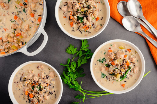 Bowls Of Chicken And Wild Rice Soup: Overhead View Of Creamy Chicken And Wild Rice Soup With Spinach And Carrots