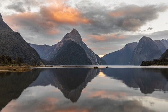 New Zealand, Mitre Peak reflecting on shiny surface of Milford Sound at dusk