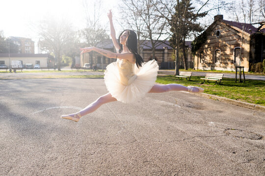 Italy, Verona, Ballerina dancing in the city jumping midair
