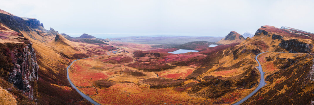 UK, Scotland, Drone panorama of empty highway stretching along brown mountainous landscape of Isle of Skye