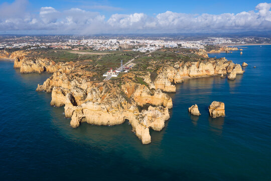 Portugal, Algarve, Lagos, Drone view of Ponta da Piedade headland and Farol da Ponta lighthouse
