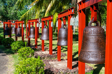 China, Hainan, Sanya, Row of large bells inside Nanshan Temple