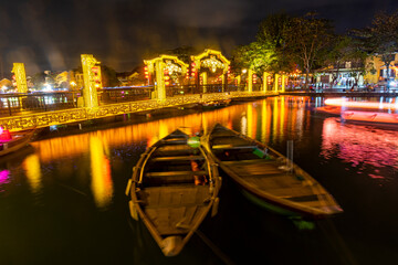Vietnam,ÔøΩHoiÔøΩAn, Boats on river in old town illuminated at night