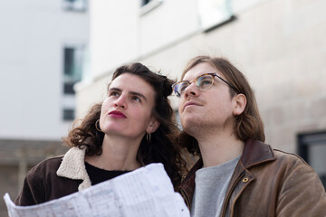 Thoughtful couple with blueprint