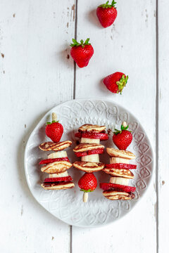 Plate of mini pancakes with strawberries and bananas